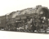 An oblique front view of a 2-8-4 steam locomotive.