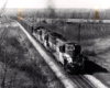 Two Toronto, Hamilton & Buffalo diesel locomotives with freight train.