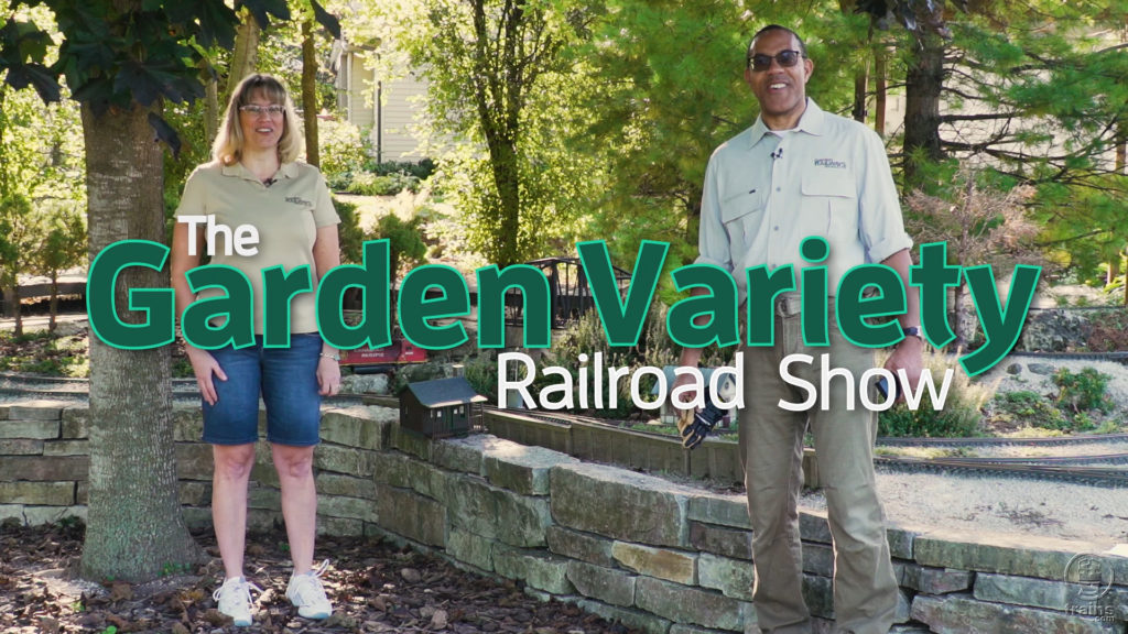 Rene Schweitzer and Kent Johnson standing by a garden railroad