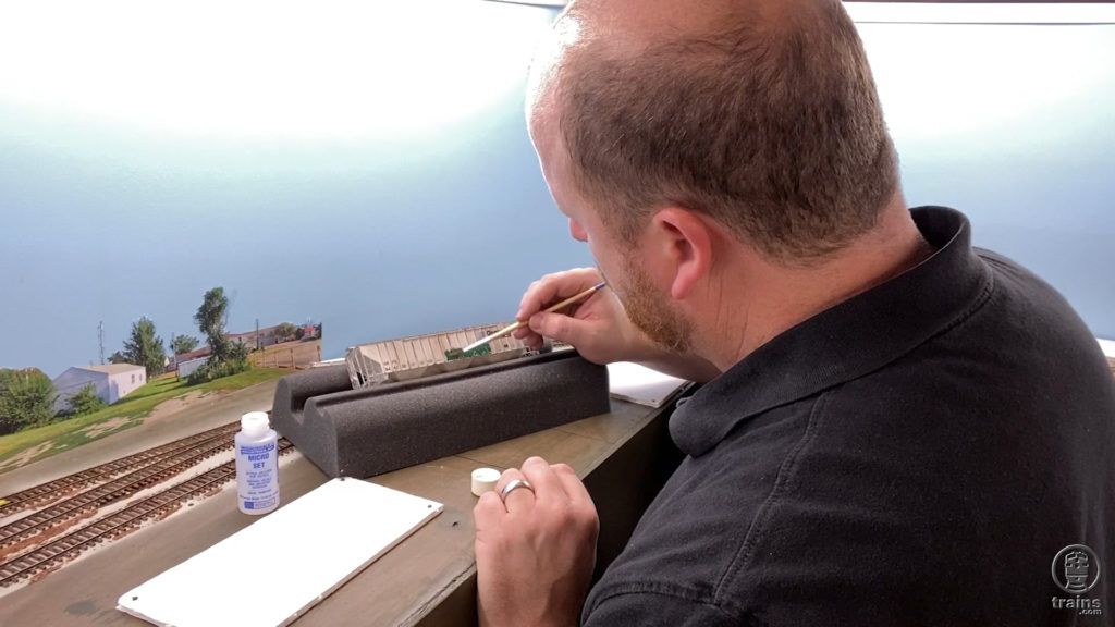 James McNab weathering an HO scale boxcar