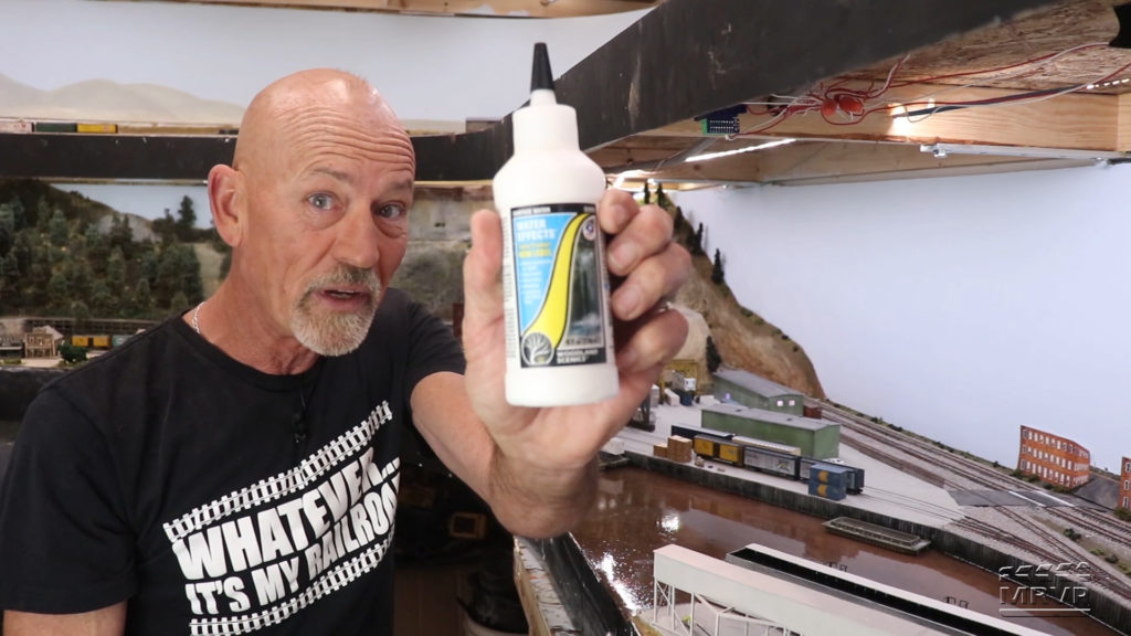 Steve Brown holding up a bottle of Woodland Scenics Water Effects