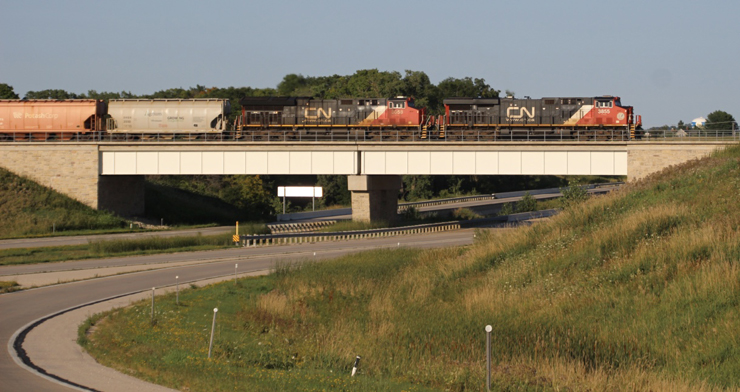 Freight train on bridge over highway