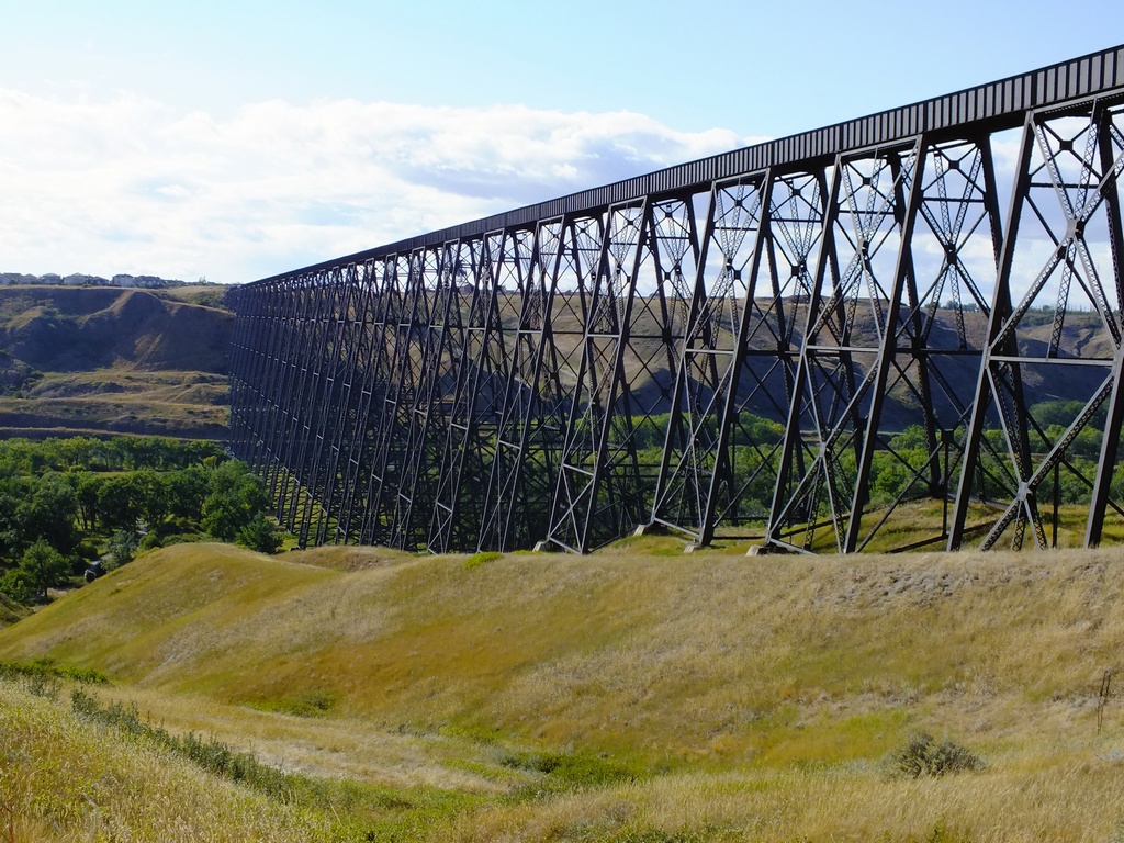 Long steel bridge in a prairie landscape.