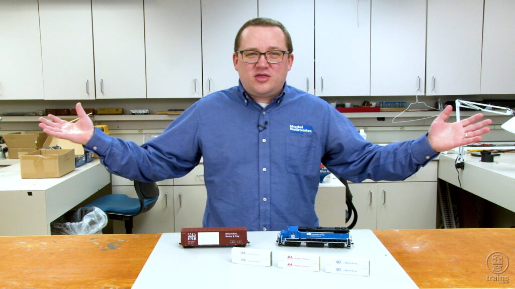 Cody Grivno in Model Railroader workshop with Atlas GP38-2, Accurail 50-foot boxcar, JRT Model Trains 53-foot container