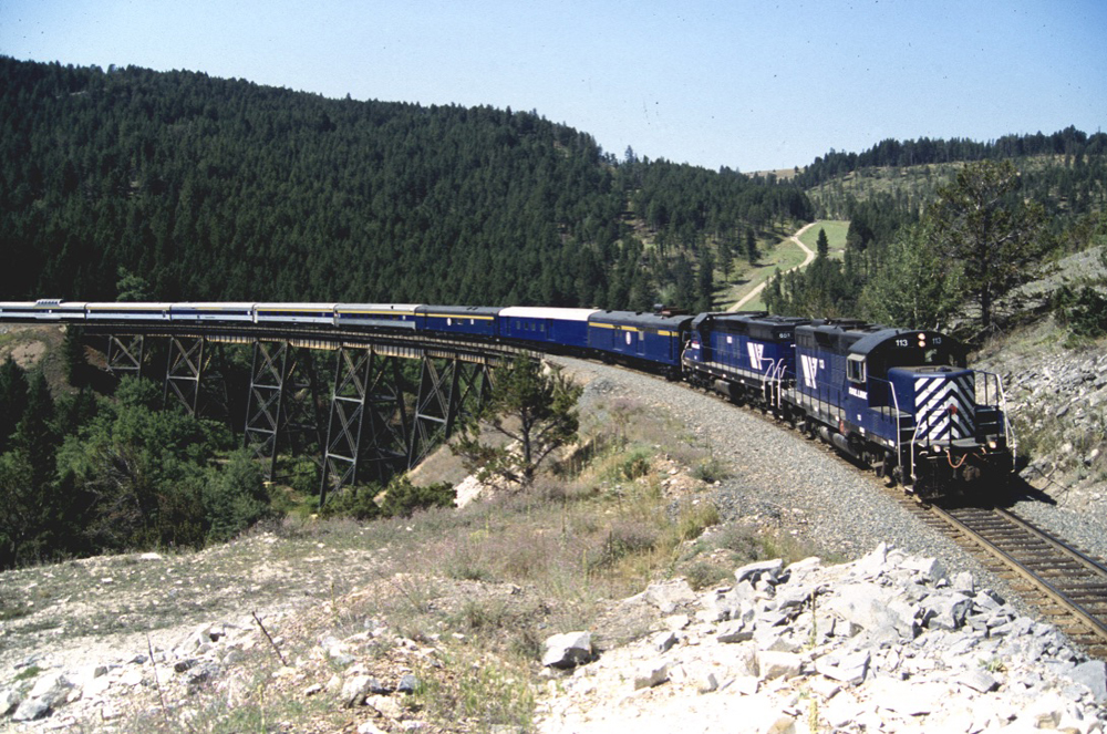 Passenger train curves over bridge