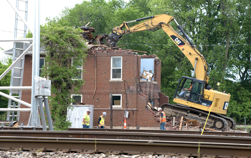 Heavy equipment tearing down brick buidling