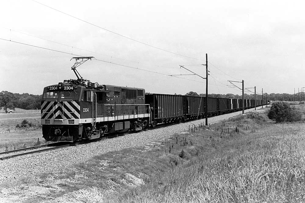 Electric locomotive pulls coal train on private railroad