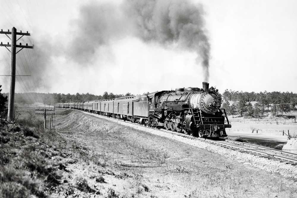 Steam-powered heavyweight passenger train on curve