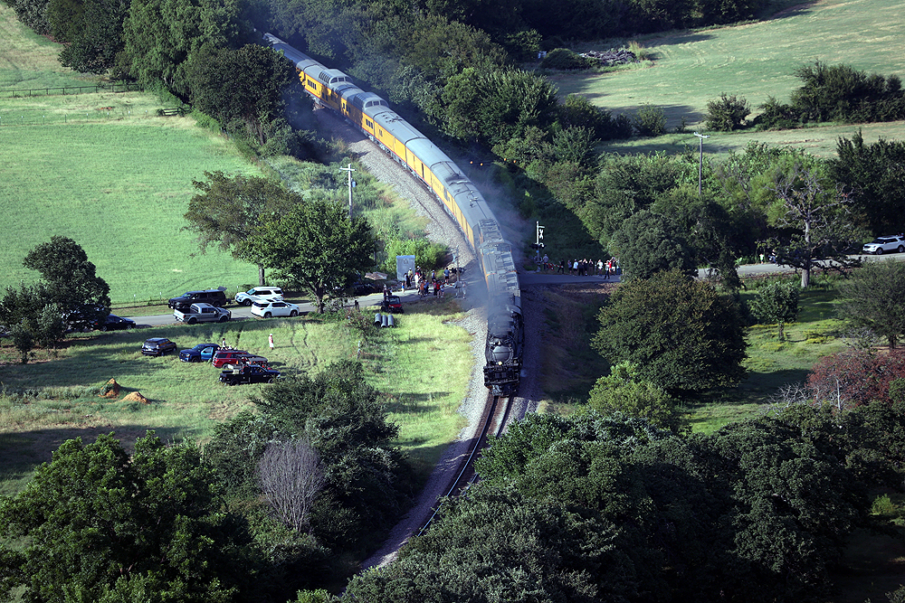 Big Boy locomotive moving over a rural grade crossing.