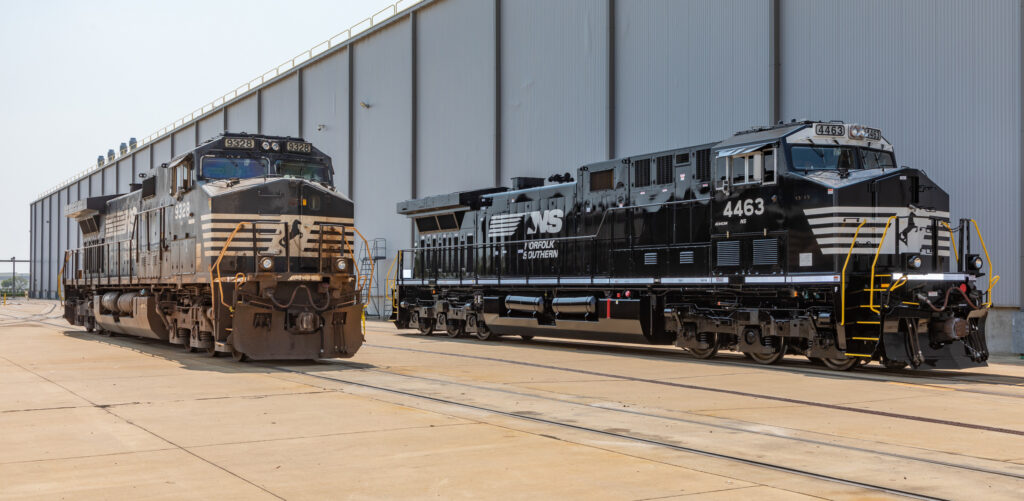 Two black locomotives, one weathered, the other new and shiny