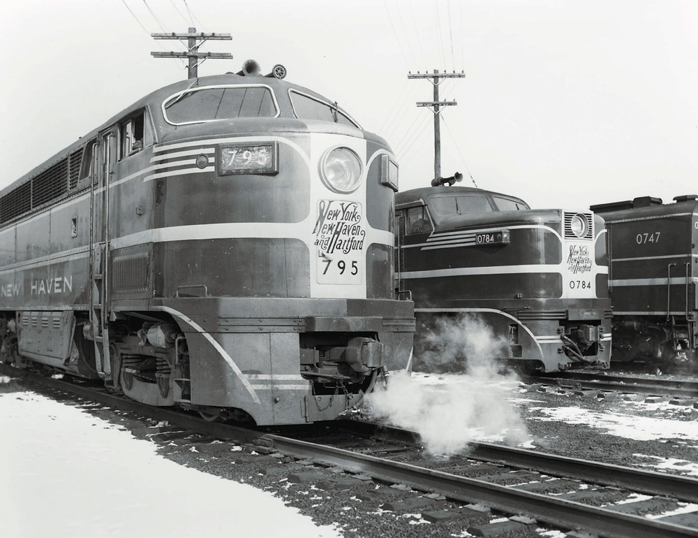 Black-and-white photo of the noses of two streamlined diesel locomotives.