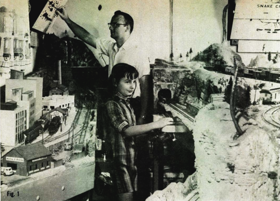 Vintage photo with man and girl near model railroad