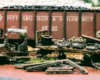 A rusted and broken-down antique truck rests trackside in front of a Pittsburg & Shawmut coal hopper
