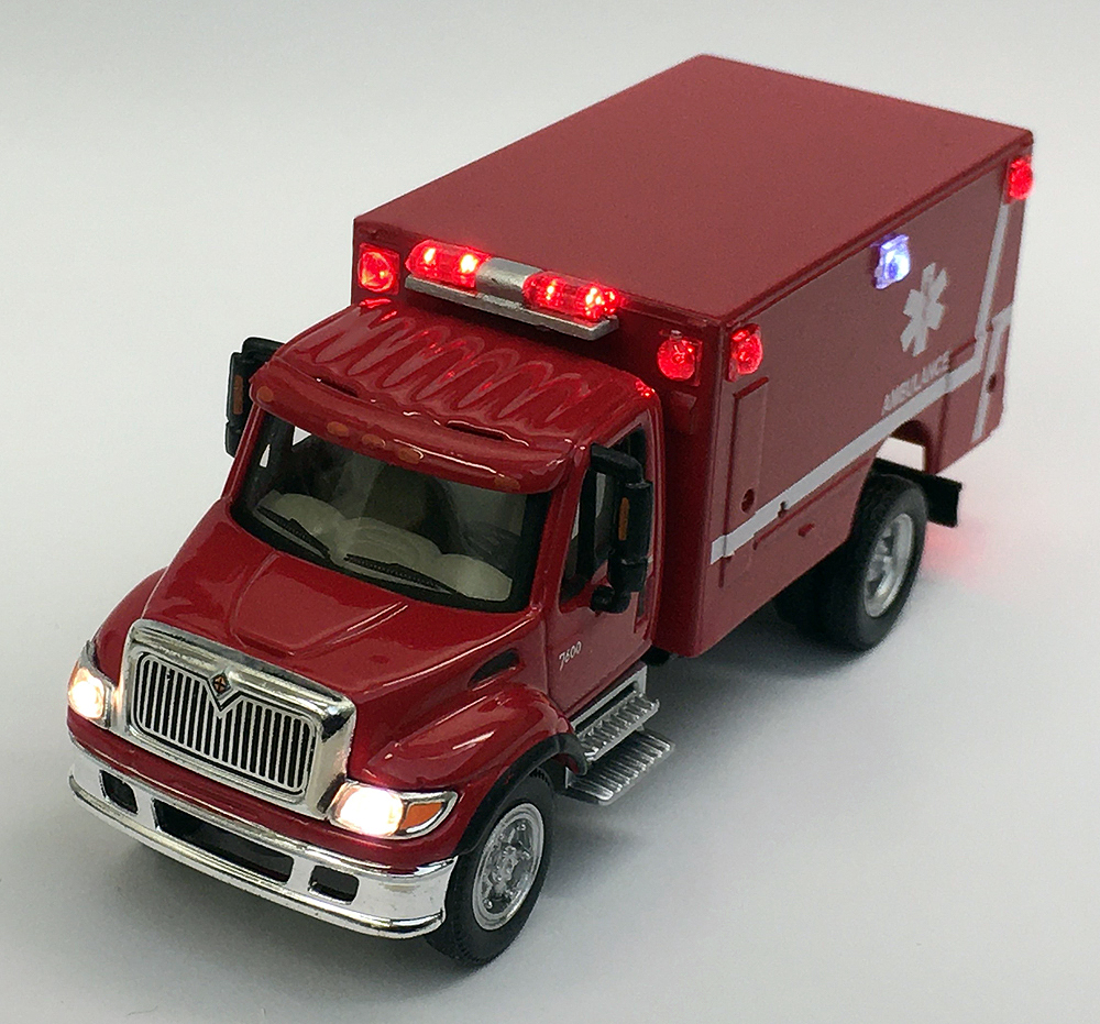 Dark red HO scale Walthers SceneMaster ambulance with custom lighting.