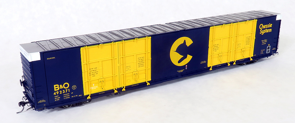 Dark blue and bright yellow 86-foot high-cube quad-plug-door boxcar