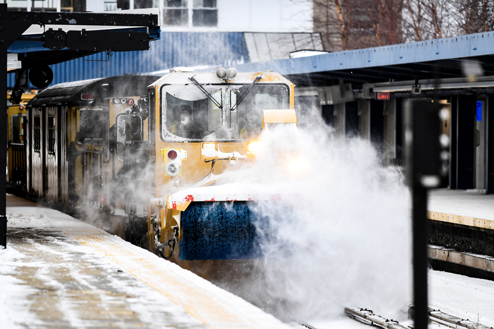 Snow-clearing equipment leads train through subway station