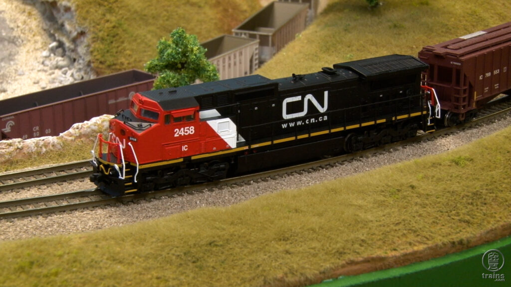 Red and black Canadian National locomotive on N scale layout.