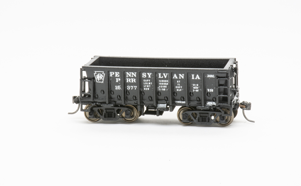 Photo of HO scale Pennsylvania RR class G38 ore car painted black with white graphics on white background.