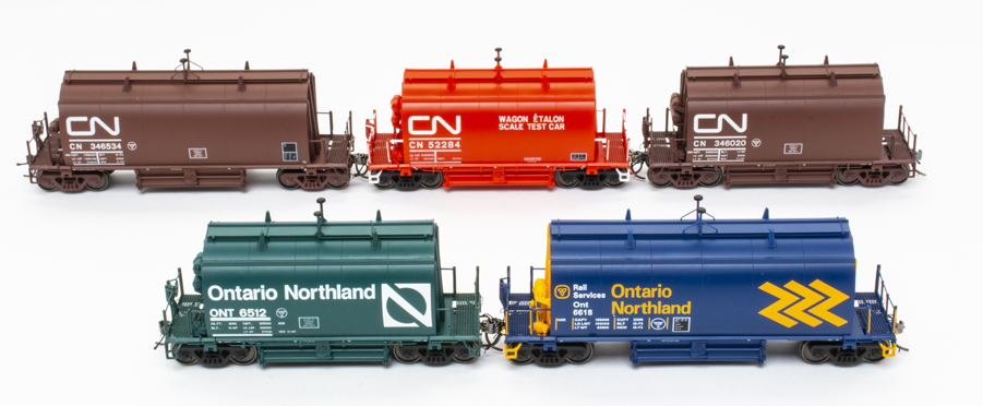 Five HO scale barrel ore cars in various Canadian National and Ontario Northland paint schemes on white background.