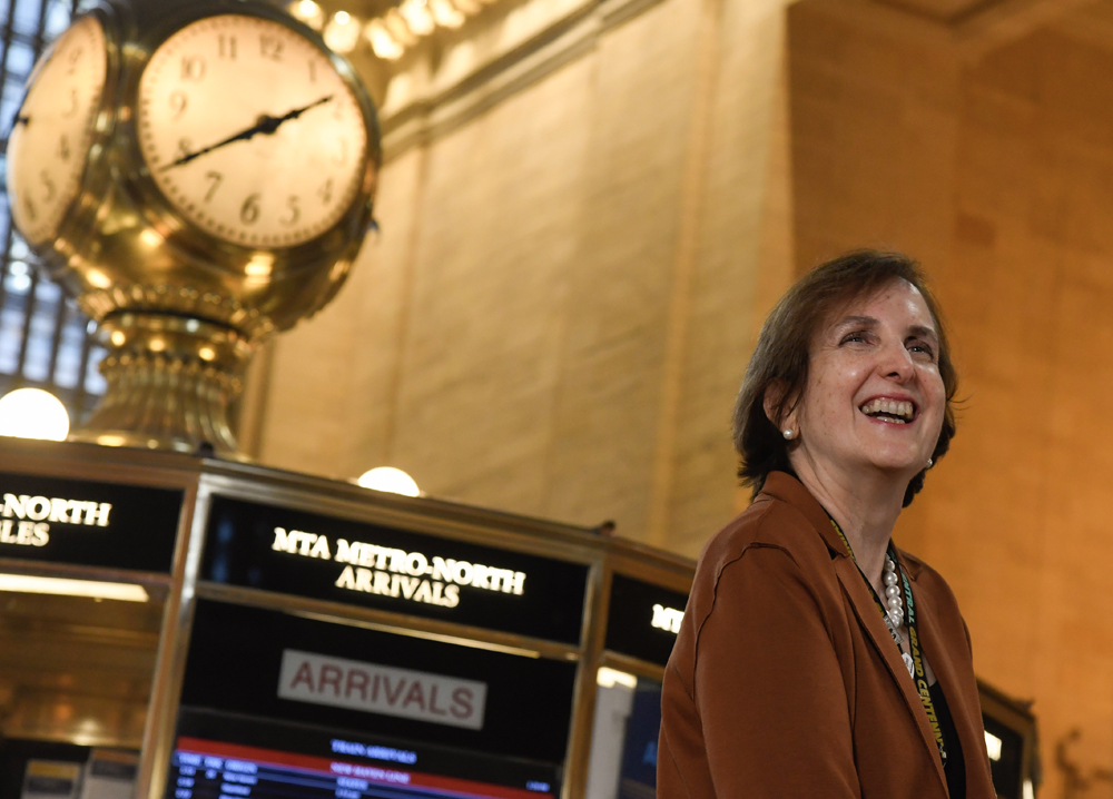 Woman at Grand Central Terminal with clock in background