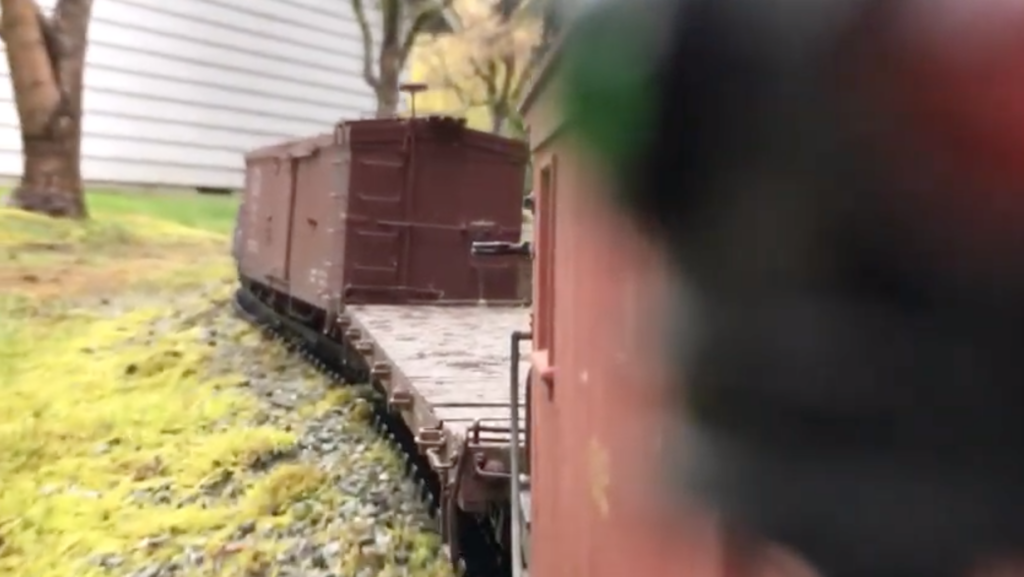 view of garden railroad from a caboose camera