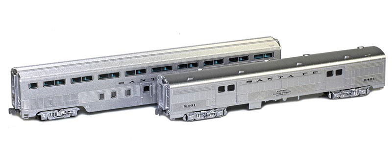 Photo of two Z scale lightweight passenger cars painted silver with black lettering.