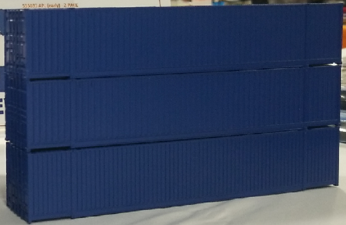 Photo of three HO scale 53-foot intermodal containers painted dark blue.