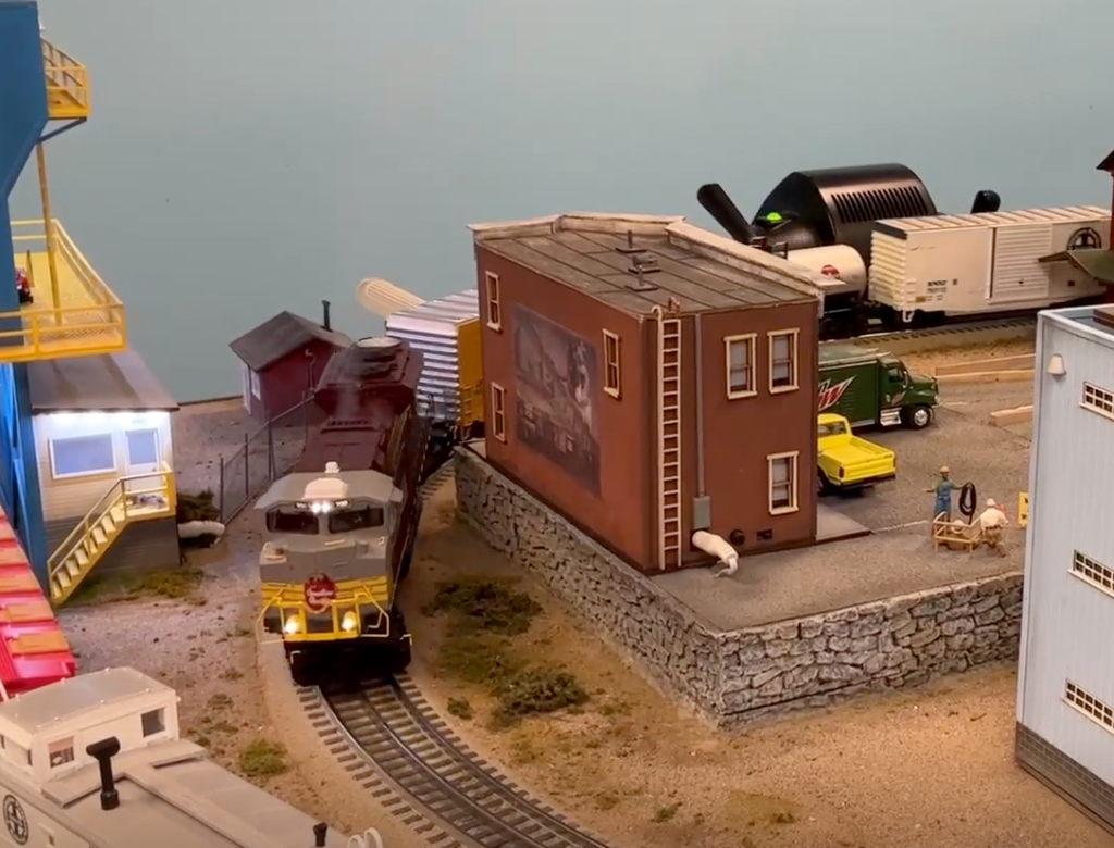 Toy train layout with lighted locomotive.