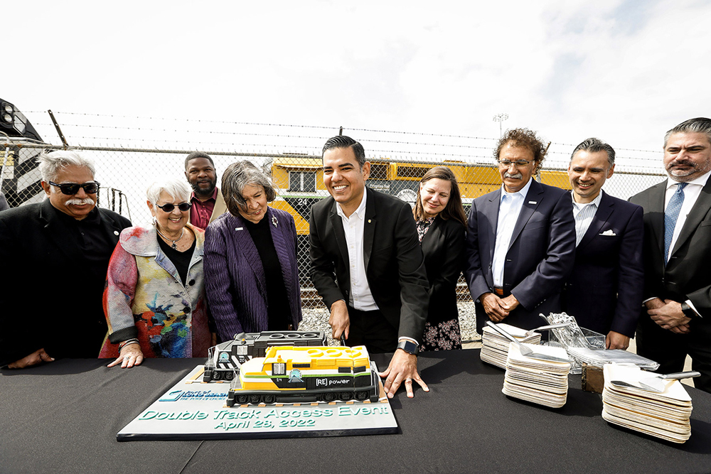 People gathered for ceremony in front of locomotive