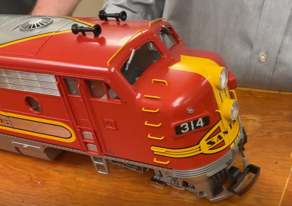 Red, yellow, and silver locomotive model close-up.