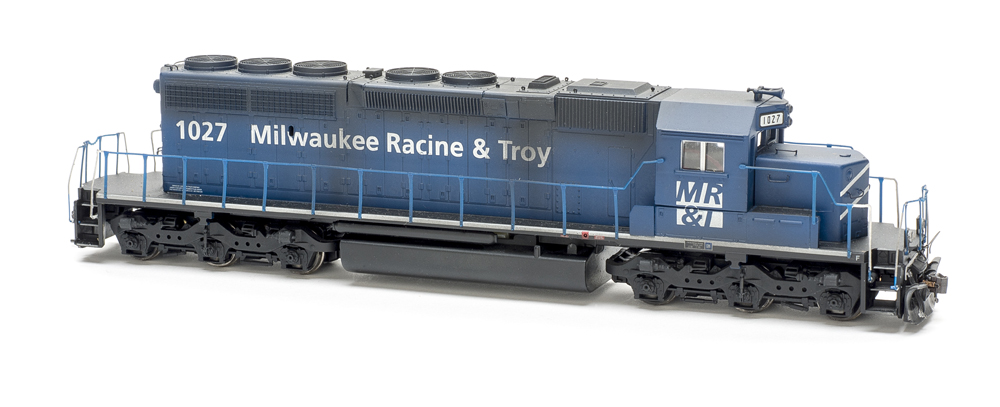 Photo of weathered dark blue six-axle road unit on white background