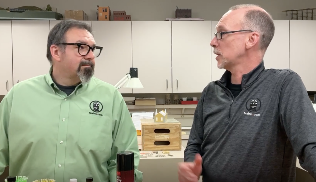 Two men talking in a workshop.