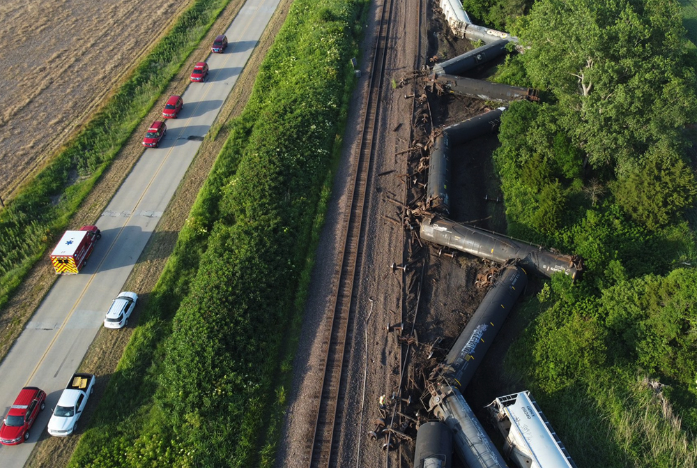 Aerial view of derailment on track next to highway