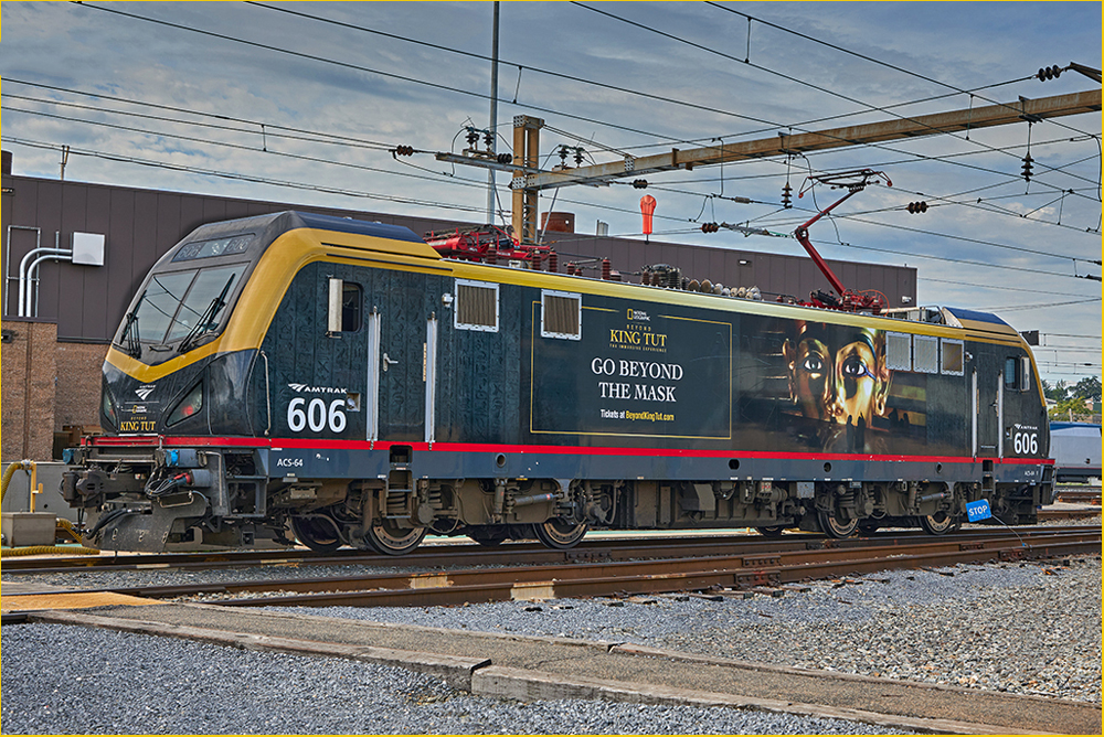 Locomotive wrapped in blue and gold design featuring King Tut mask