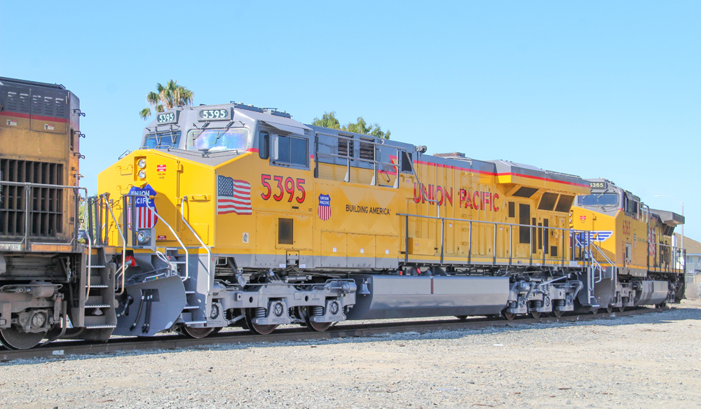 Yellow and gray locomotive with red trim