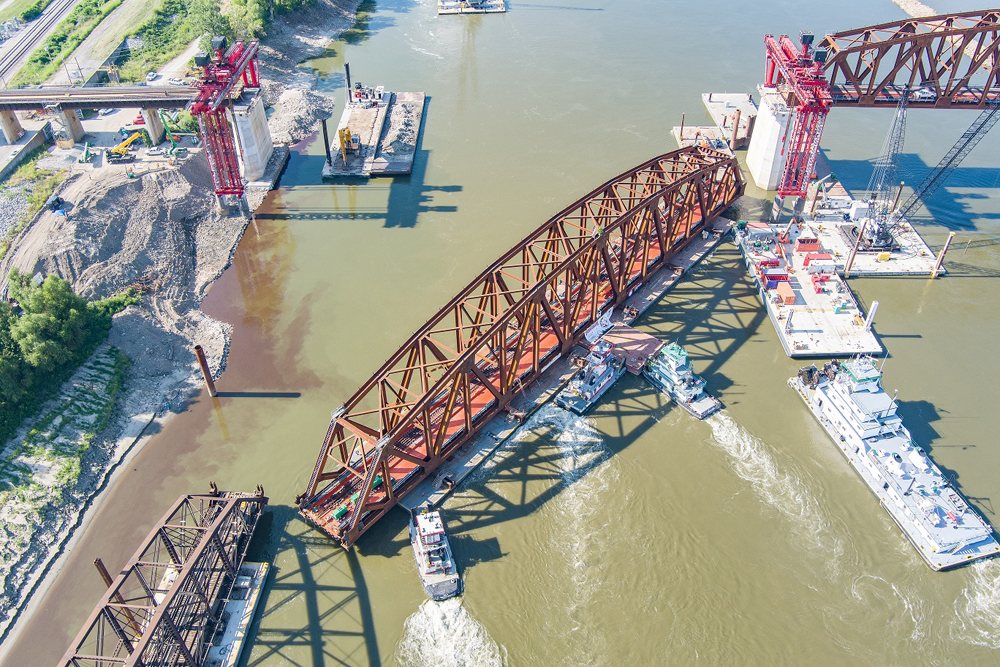 Aerial view of steel structure being moved by boats