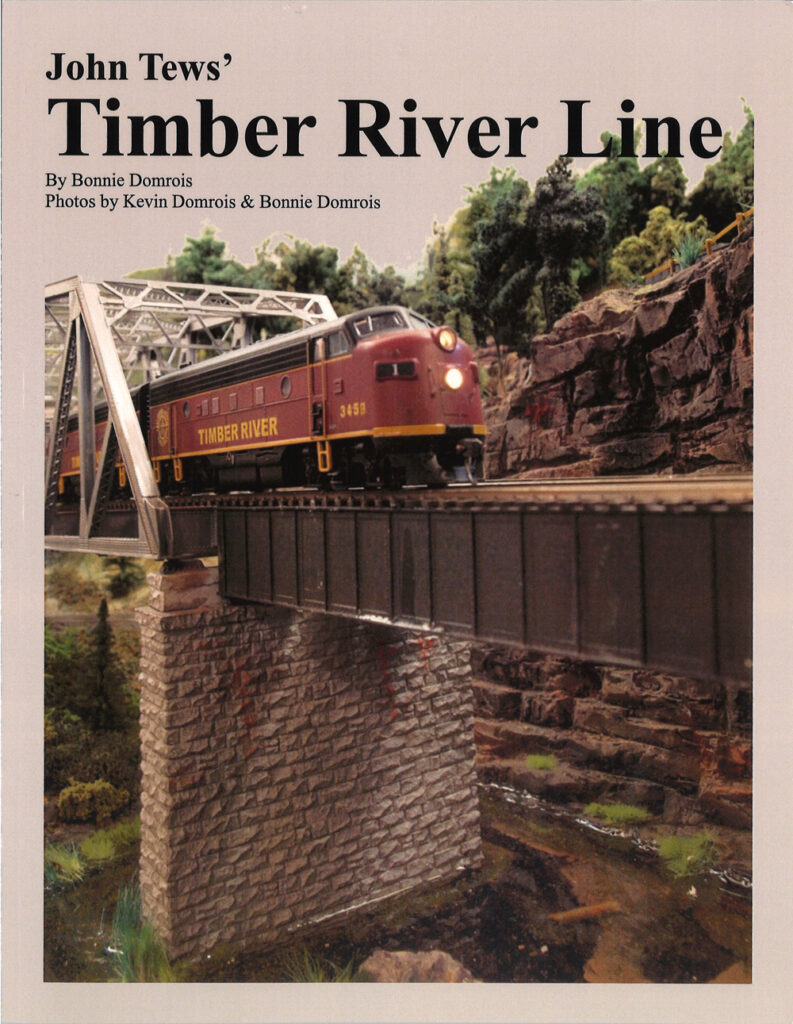 Book cover with model of streamlined diesel locomotive on bridge