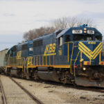 Blue and yellow locomotives switching