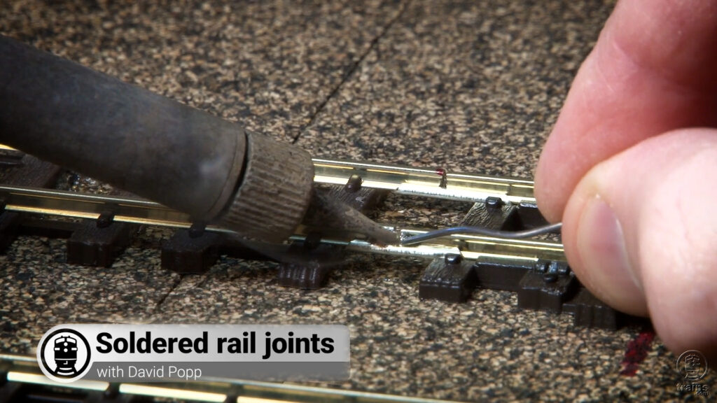 Better rail joiners for your layout: rail joiners being soldered on a model railroad layout