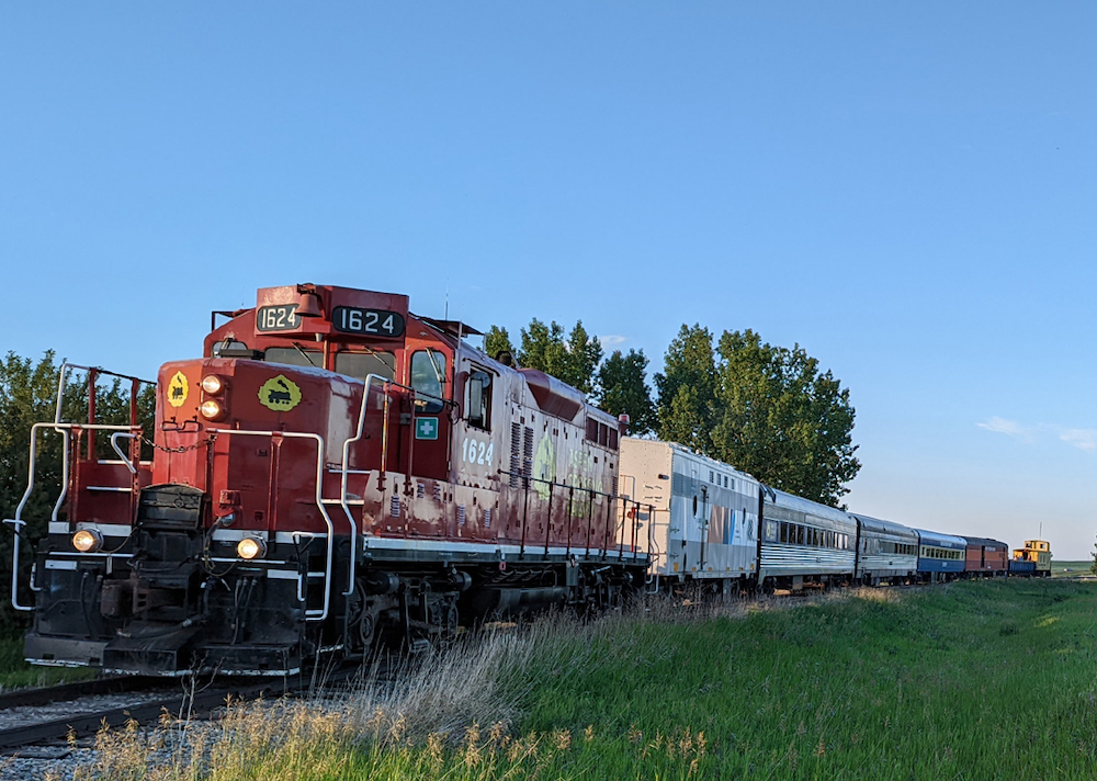 Diesel-powered excursion train rounding a curve.
