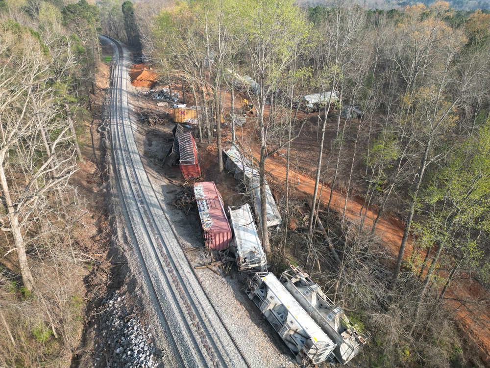 Derailed freight cars next to rebuilt right-of-way