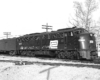 Black-and-white diesel locomotive flying black flags