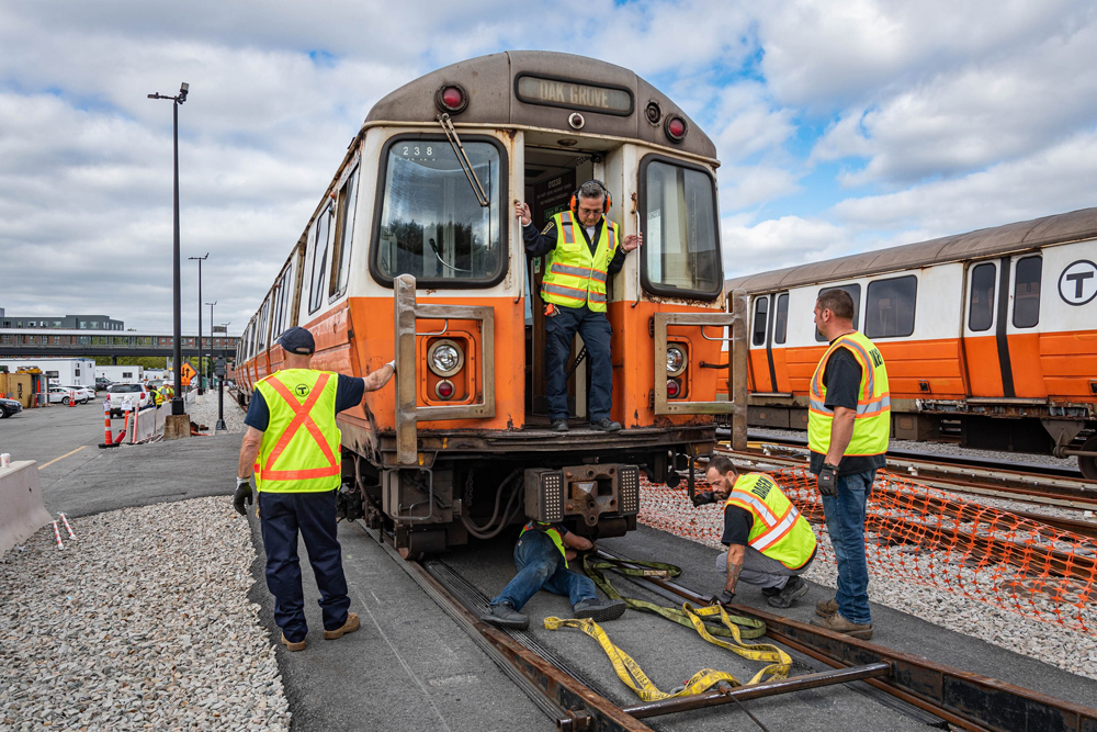 Men working on MBTA Orange Line car