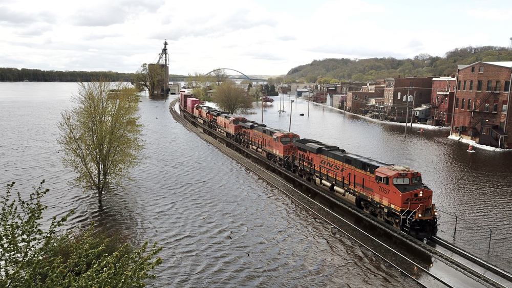 Train on tracks surrounded by floodwater