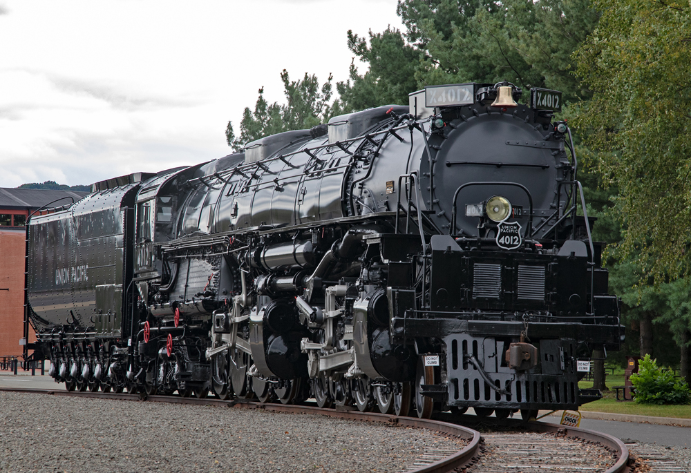 Large black articulated steam locomotive at a museum.