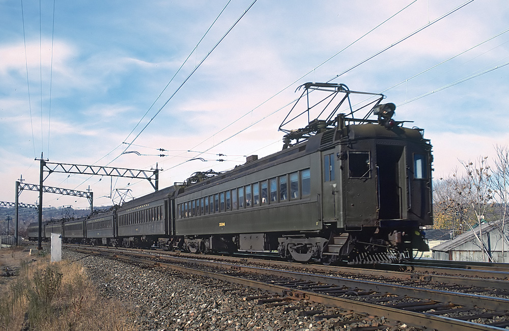 A six-car Erie Lackawanna electrified passenger train rolls under wire