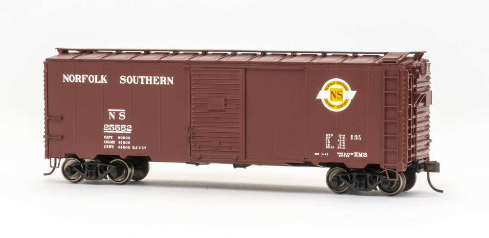 Color photo of HO scale 40-foot boxcar painted brown with white, yellow, and red graphics.