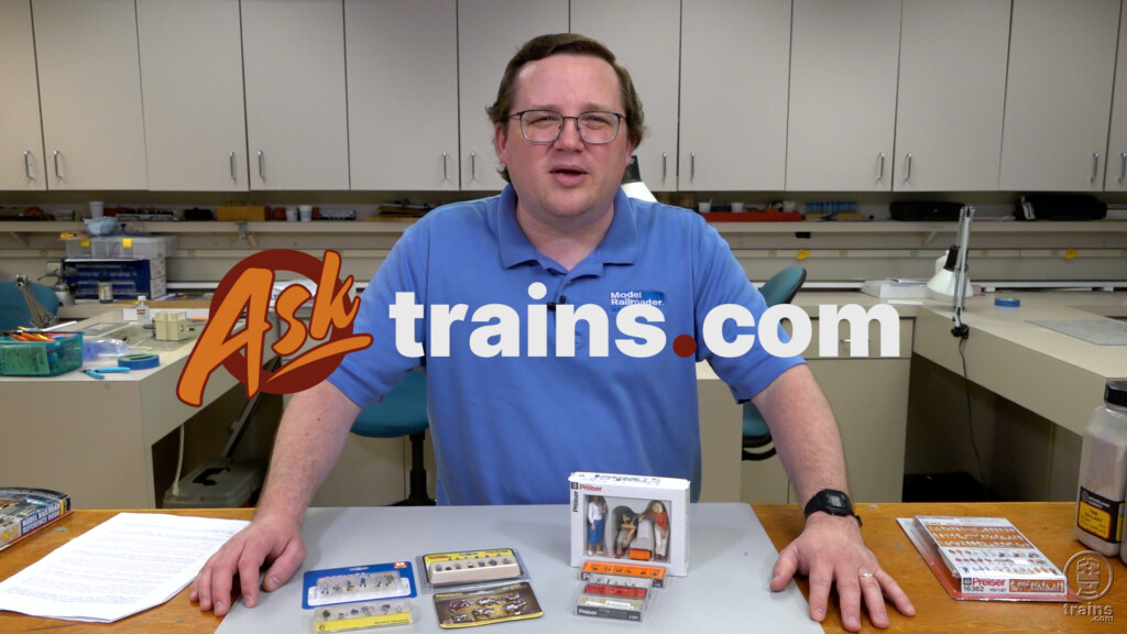 Ask Trains.com June 2023 compilation part two: An image of a man in a blue shirt standing behind a table