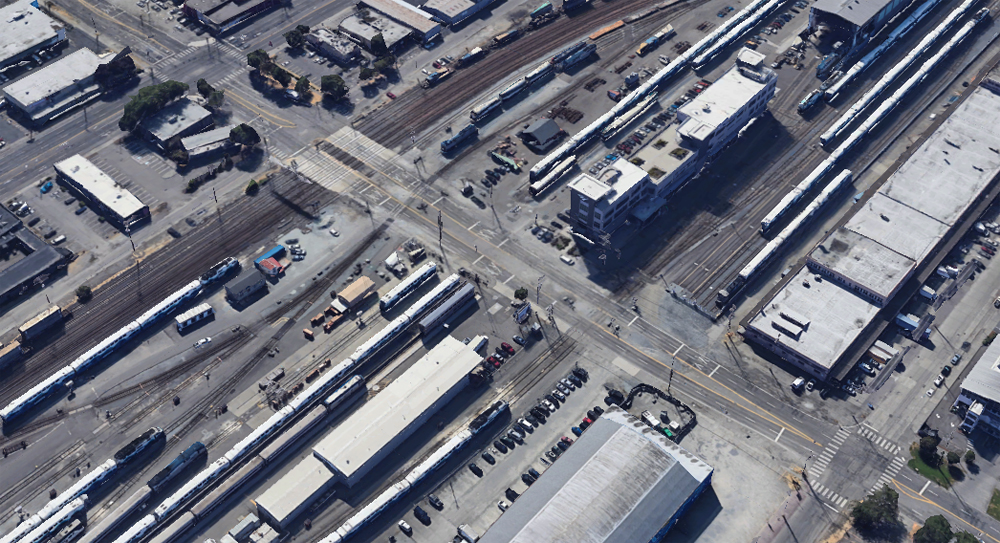 Aerial view of street running through railroad yard