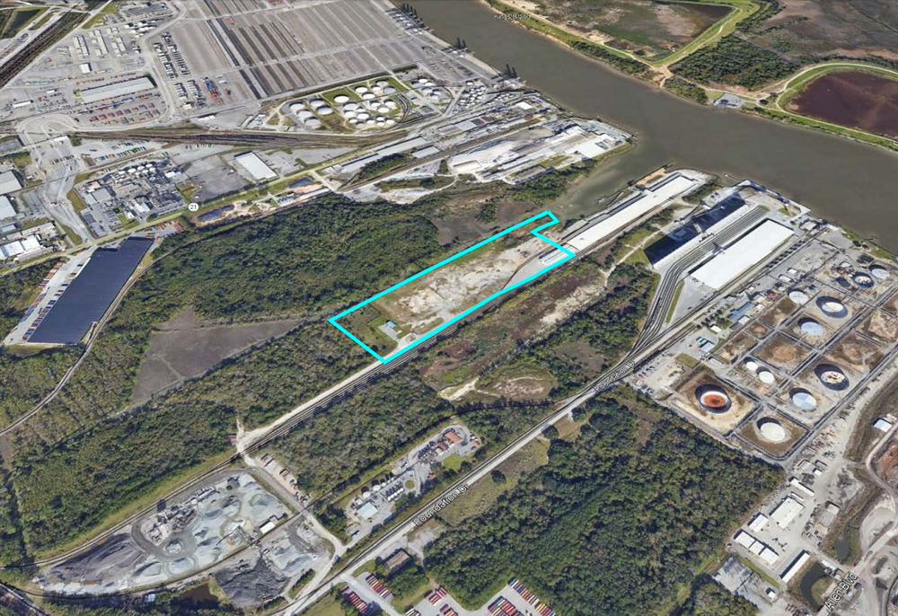 Aerial view of industrial properties with one lot outlined in blue